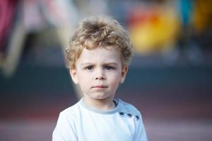 Portrait of a young curly-haired boy photo