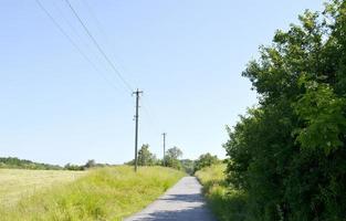 Beautiful empty asphalt road in countryside on colored background photo