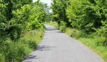 Beautiful empty asphalt road in countryside on colored background photo