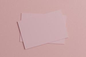 Pink pastel business card paper mockup template with blank space cover for insert company logo or personal identity on cardboard background. Modern style concept. Top view. 3D illustration render photo