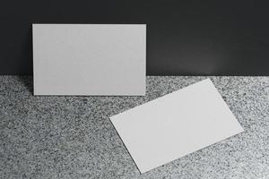 White business card paper mockup template with blank space cover for insert company logo or personal identity on marble floor background. Modern concept. 3D illustration render photo