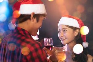 Asian lovers eye contact looking and smiling to each other in pub. Honeymoon and Holiday concept