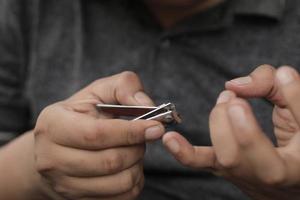 A man cuts his nails photo