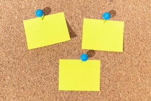 Group of Yellow sticky notes on a cork board for adding text. Template Mock up photo