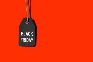 Black friday tag isolated on red background with copy space photo