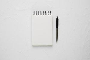White blank spiral notepad with ballpoint pen