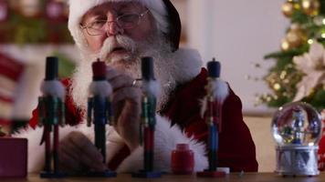 Santa Claus painting toys in workshop video