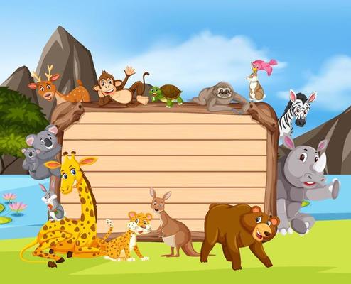 Empty wooden board with various wild animals in the forest