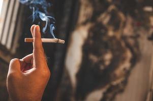 Close up male hand holding a cigarette photo