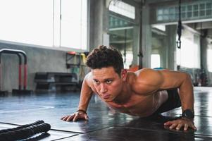 Fitness man doing push up in gym