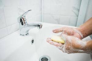 Close up male hands washing hands with soap photo