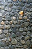 muro de piedra de guijarros foto