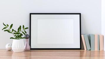 A picture frame on the floor with a flower vase. photo