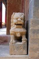 Stone lion statue in Tulou Temple of Beishan Mountain China.