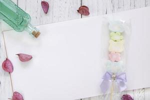 White painted wood table with paper and candy photo