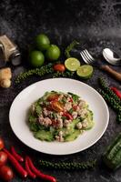 Stir fried zucchini with minced pork in white plate photo