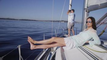 Young woman relaxing on sailboat. Shot on RED EPIC for high quality 4K, UHD, Ultra HD resolution.