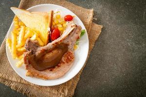 Pork chop steak with chips and mini salad photo