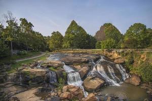 Cascading waterfall in the middle of a forest photo