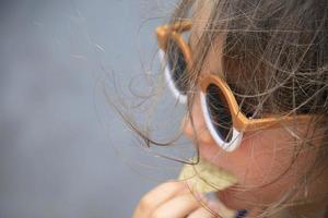 Little girl eating some chips and salsa at a table photo