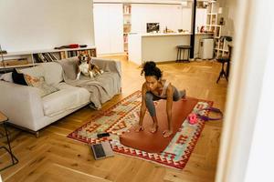 Black young woman does yoga at home  photo