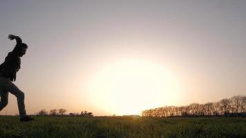 young happy male jump in the summer fields video