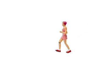 Miniature people, Woman in fitness wear running on white background photo