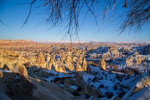 Fairy tale chimneys in Cappadocia with blue sky on background. Love Valley in Cappadocia photo