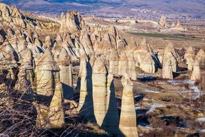 Fairy tale chimneys in Cappadocia with blue sky on background. Love Valley in Cappadocia photo
