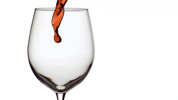 slow-motion shot van rode wijn gieten in glas op witte achtergrond. geschoten op phantom flex 4k met 1000 fps video