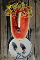 Watermelon And Other Fruits As Funny Face. Autumn Picnic In The Garden. Festive Harvest Background. photo