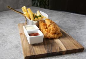 Traditional British Fish and Chips with french fries photo