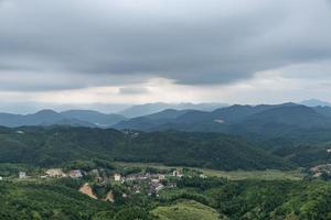 A country surrounded by forests on a cloudy day photo