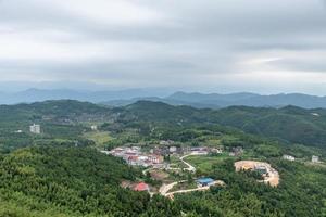 A country surrounded by forests on a cloudy day photo