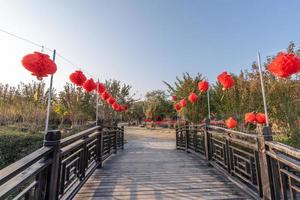 At dusk, the walking road in the park is decorated with many lanterns photo