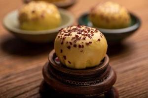 Cut and complete the egg yolk steamed stuffed bun on the wood grain table photo