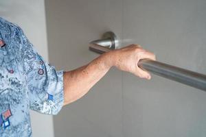 Asian senior or elderly old lady woman patient use toilet bathroom handle security in nursing hospital ward, healthy strong medical concept photo