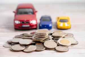 Car on coins background Car loan, Finance, saving money, insurance and leasing time concepts photo