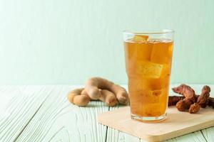 Delicious sweet drink tamarind juice and ice cube photo