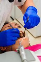 the use of a retractor while brushing teeth from tartar. photo