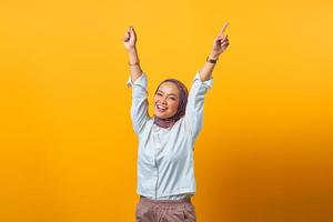 Portrait of cheerful Asian woman with victory expression photo