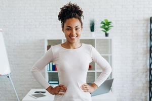 Cute, smiling girl standing in the middle of the room on a desktop background photo