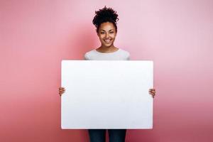 Young woman in holding in hands empty letter in front of her photo