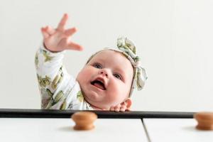 Beautiful, pretty baby girl wants to take something with her little pen photo