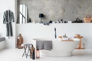 Modern bathroom interior with minimalistic shower and lighting, white sink and bathtub photo