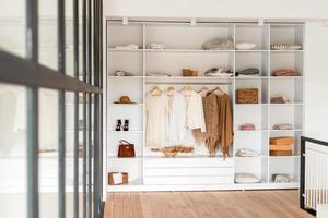 Modern interior, beautiful wardrobe with clothes photo