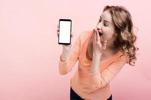 Shocked young woman looking at phone screen. Place for advertising photo