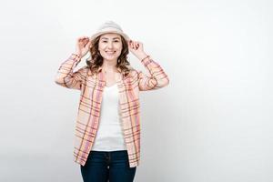 Girl with hat and colorful hat on white wall background photo