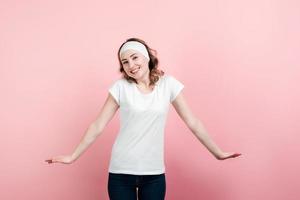 Happy woman wearing in casual clothes  with apart hands standing over  pink background photo