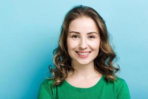 Closeup portrait of pretty smiling curly  woman wearing in green sweater photo